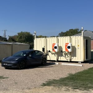 Portrait pic charging black Tesla