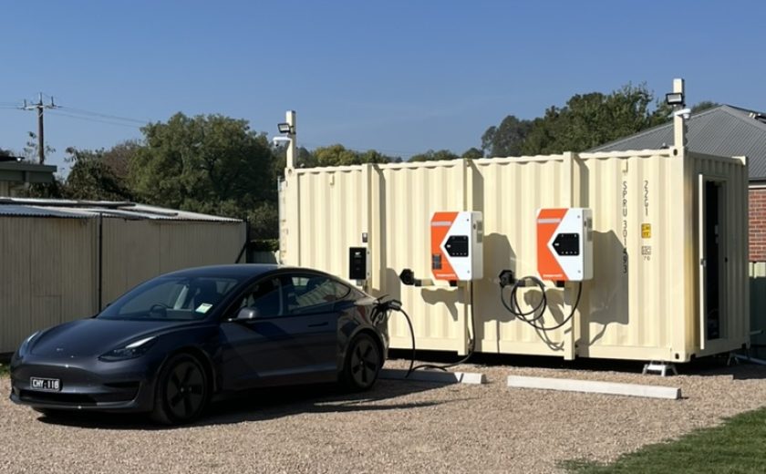 Portrait pic charging black Tesla